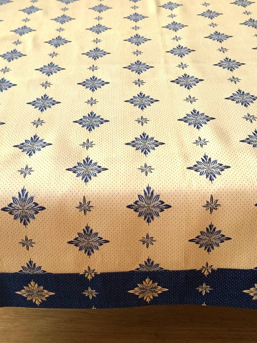 Elegancki obrus typu adamaszek w kremowym kolorze z granatowym geometrycznym wzorem